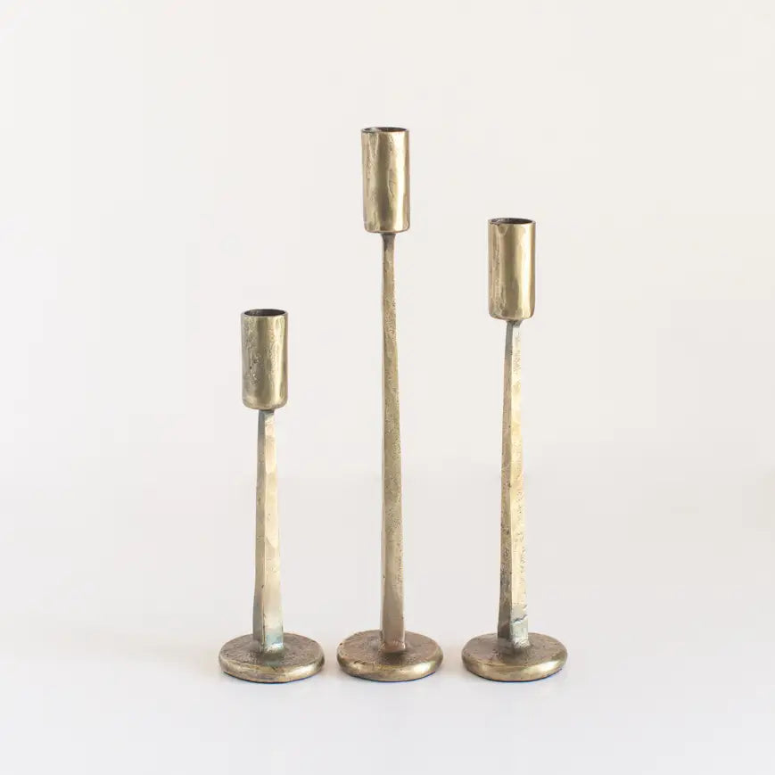 Set of three vintage black iron candlesticks in varying heights for elegant home decor