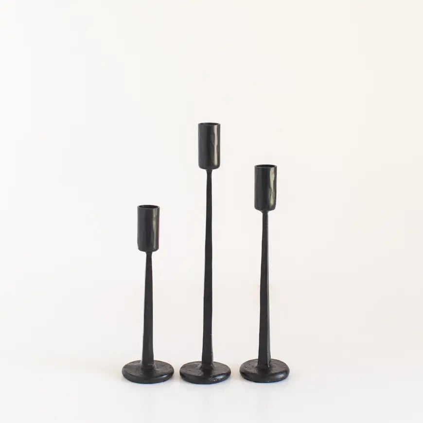 Set of vintage black iron candlesticks in three varying heights for elegant décor